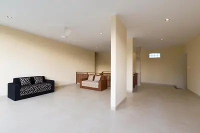 a living room with a couch and a chair at Kubu Petitenget Suite Seminyak in Seminyak