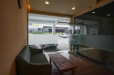 a living room with a couch and a table at Dee Mansion Bali in Denpasar
