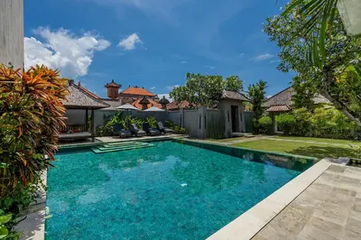 a swimming pool in the backyard of a house at Bali Villa Lotus in Seminyak