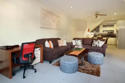 a living room with a couch and a desk at Villa Nova in Legian