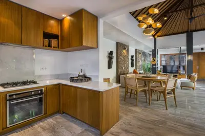 a kitchen and dining room with a table and chairs at Villa Dee 6 in Seminyak