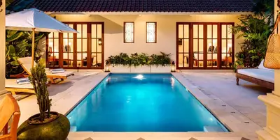 a swimming pool in the middle of a house at Villa Tsuchi in Seminyak