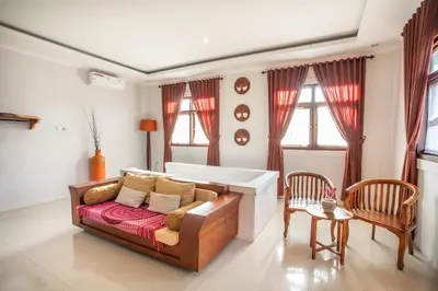 a living room with a couch and two chairs at Villa Rani 3 in Seminyak
