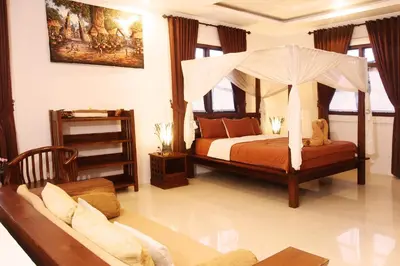 a bedroom with a bed with a canopy at Villa Rani 3 in Seminyak