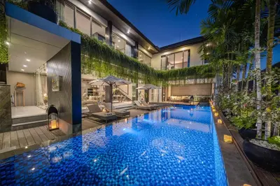 a large swimming pool in the middle of a building at Villa Balimu Seminyak in Seminyak