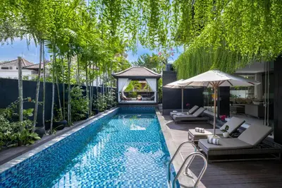 a swimming pool with a gazebo and a house at Villa Balimu Seminyak in Seminyak