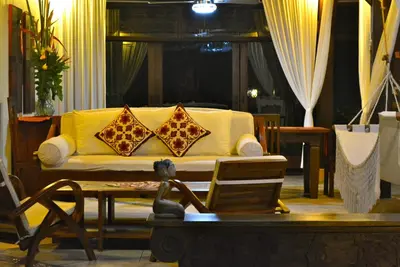 a living room with a couch with pillows on it at Villa Una in Seminyak
