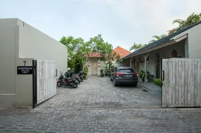 a car parked in a parking lot next to a building at Ambermoon Villas in Seminyak