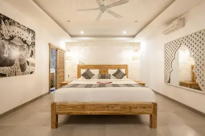 a bedroom with a bed and a ceiling fan at Ambermoon Villas in Seminyak