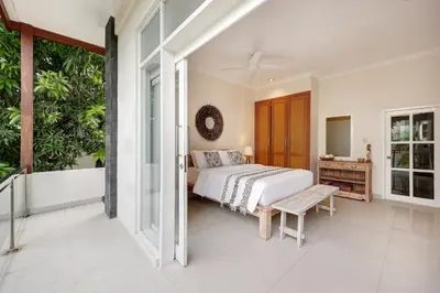 a bedroom with a bed and a balcony at Villa Alba in Seminyak