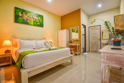 a bedroom with a bed with a rabbit sitting on it at The Rani Garden Bed & Breakfast in Denpasar