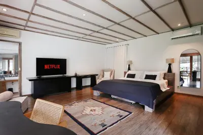 a bedroom with a king sized bed and a tv at Maya Villa - Seminyak in Seminyak