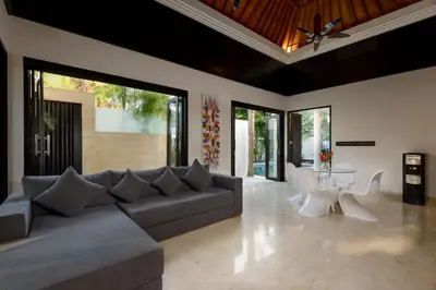 a living room with a couch and a table at Villa Maharani in Seminyak