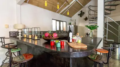 a bar in a room with chairs and a table at Luxury Villa Kudeta 300m BEACH and heart of Seminyak in Seminyak