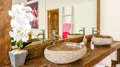 a bathroom with two sinks and two mirrors at Luxury Villa Kudeta 300m BEACH and heart of Seminyak in Seminyak