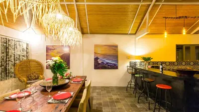 a dining room with a table and a bar at Luxury Villa Kudeta 300m BEACH and heart of Seminyak in Seminyak