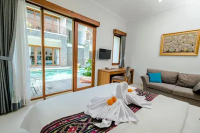 a bedroom with a bed with two swans on it at Mahana Living in Denpasar