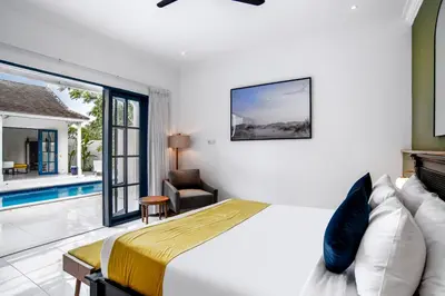 a bedroom with a bed and a pool at The Beach House in Canggu