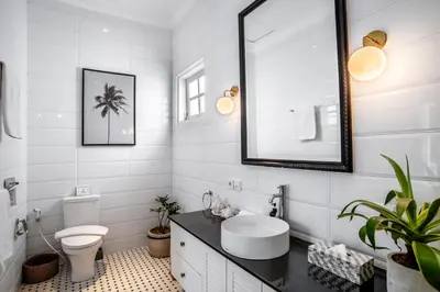 a white bathroom with a sink and a toilet at The Beach House in Canggu
