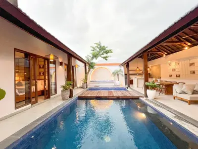 a swimming pool in the middle of a house at Apple Villa & Suite Seminyak in Seminyak