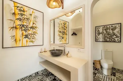 a bathroom with a sink and a mirror at Villa Dipta in Seminyak