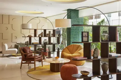 a living room with chairs and tables and furniture at Kleo Seminyak, part of JdV by Hyatt in Seminyak