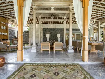 an indoor dining room with a table and chairs at Mannao Estate by Villa Finder in Kerobokan