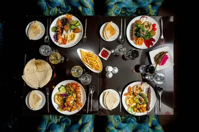 a table with plates of food on it at Imani Suites in Seminyak