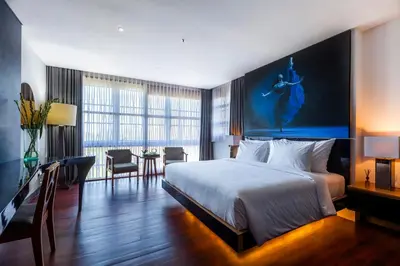 a hotel room with a bed and a table and chairs at Imani Suites in Seminyak
