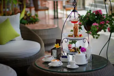 a table with a tray of food and cups on it at Royal Tulip Springhill Resort Jimbaran in Jimbaran