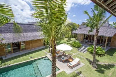 an aerial view of a house with a pool and palm trees at Alea Estate in Kerobokan