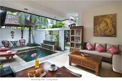 a living room with a pool in the middle at 2BR Villa Senin - Minggu Villas Seminyak in Seminyak
