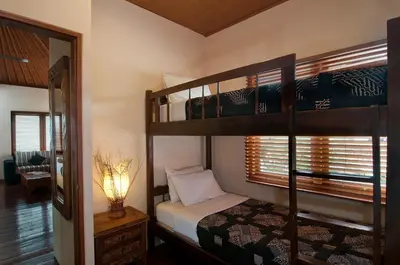 a bedroom with two bunk beds and a mirror at 4BR Villa Selasa - Minggu Villas Seminyak in Seminyak