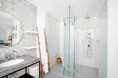 a bathroom with a shower and a sink at Benoa Sea Suites and Villas in Nusa Dua