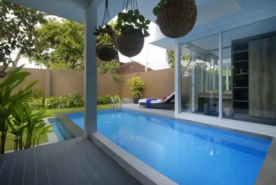a swimming pool in the backyard of a house at Benoa Sea Suites and Villas in Nusa Dua