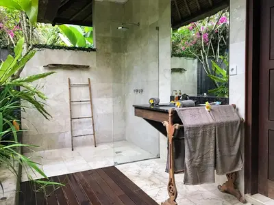 a bathroom with a shower with a sink and a mirror at Bali Villa Aja in Seminyak