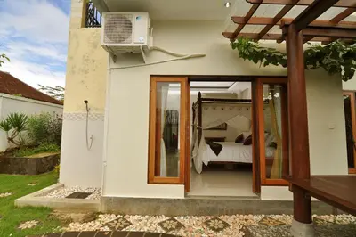a bedroom with a bed in a house at Kandava Villa in Jimbaran