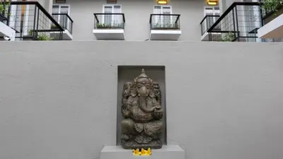 a statue in the corner of a building at Semimpi in Canggu