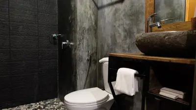 a bathroom with a toilet and a sink at Semimpi in Canggu