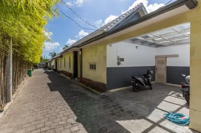 a motorcycle parked on a sidewalk next to a building at VILLA Nuri Merah 1 in Kerobokan