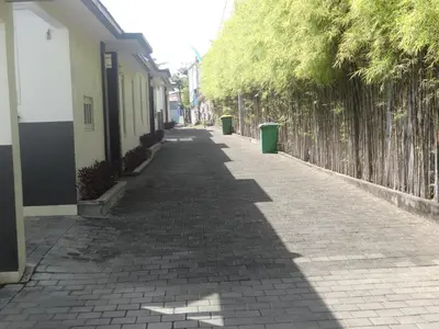 an empty street with trees on the side of a building at VILLA Nuri Merah 1 in Kerobokan