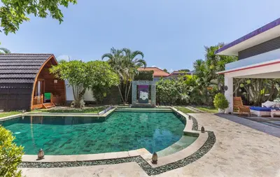 a swimming pool in the backyard of a house at Villa Purple in Legian
