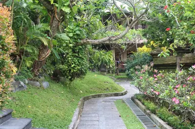 a path in a garden with flowers and plants at Bali Agung Village in Seminyak