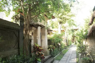 an alley in a house with a tree at Bali Agung Village in Seminyak