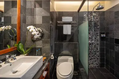 a bathroom with a sink and a toilet and a shower at Kuta Seaview Beach Resort in Kuta