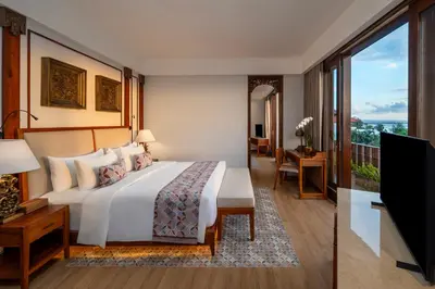 a hotel room with a bed and a television at Kuta Seaview Beach Resort in Kuta
