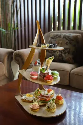 a three tiered display of pastries on a table at Kuta Seaview Beach Resort in Kuta