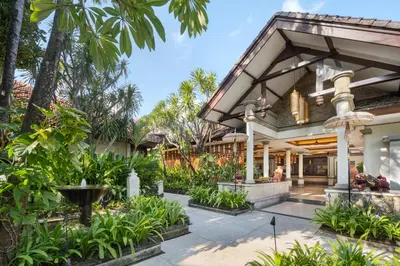 an exterior view of a house with plants at Kuta Seaview Beach Resort in Kuta