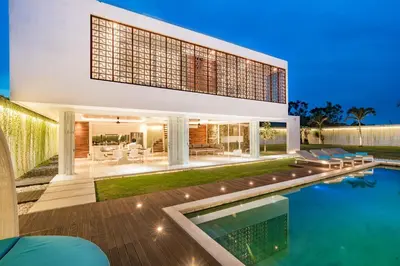 a house with a swimming pool in front of it at Villa Kamag Seminyak in Seminyak