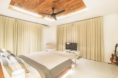 a bedroom with a bed and a ceiling fan at Villa Kamag Seminyak in Seminyak